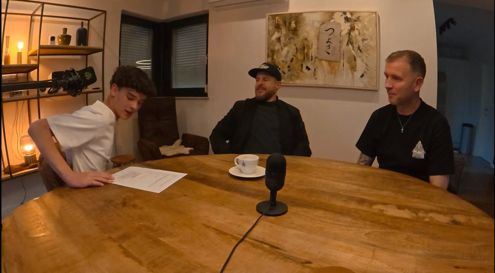 DJ Tuur at the table during a radio recording with two guests